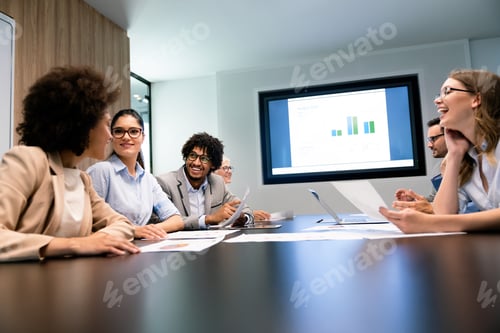 Preview: Happy business people having fun and chatting at workplace office