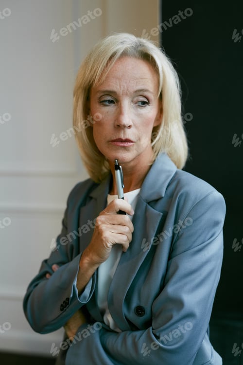 Preview: Pensive Senior Businesswoman by Window