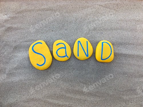 Preview: Sand word composed with yellow painted stone letters on the beach