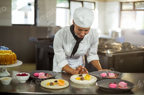 Preview: Macarons, tarts and truffles resting on steel counter near bundt cake and raspberries
