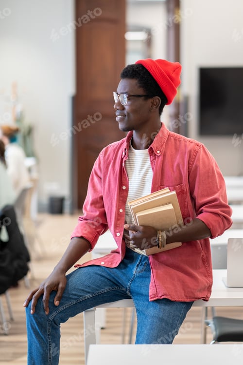 Preview: Black student guy looking out of window thinking about weekend plans while studying in library