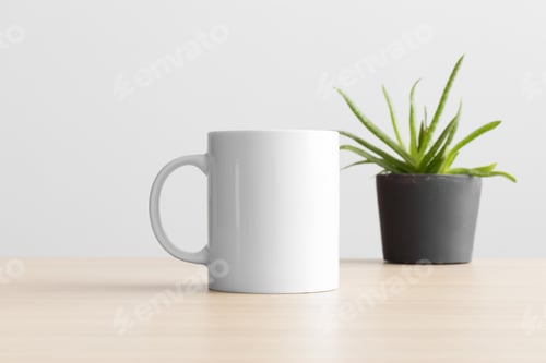 Preview: White mug mockup with a aloe vera plant on the wooden table.