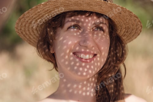 Preview: Pretty young woman drinking cocktail on the beach.