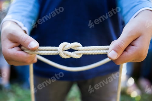 Preview: Boy's hands showing a straight knot, hiking