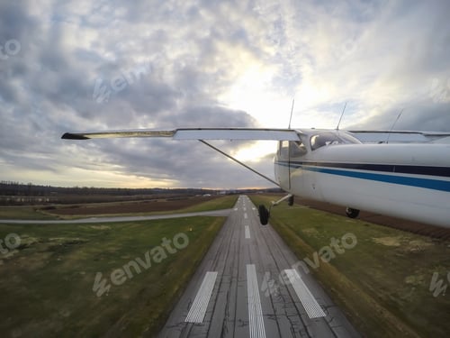 Preview: Airplane taking off from the runway during a cloudy sunset