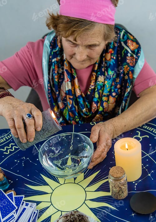 Preview: Woman fortune teller fortune telling wax candles. Selective focus.