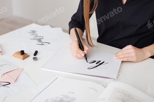 Preview: Portrait of young woman hands writing beautiful notes on paper on desk isolated