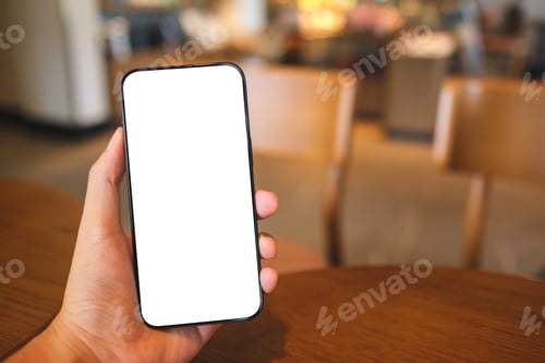 Preview: Mockup image of a man holding mobile phone with blank white screen in cafe