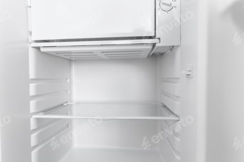 Preview: White open empty refrigerator.