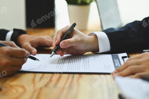 Preview: Closeup investor signing contract law conditions with business partner at meeting