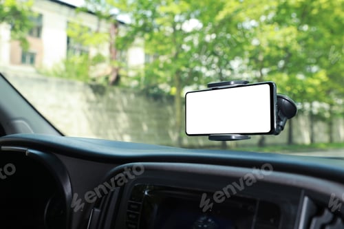 Preview: Car holder with modern mobile phone on windshield of automobile. Mockup for design