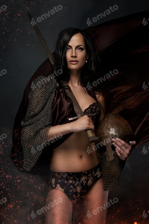 Preview: Female in war costume holding sword and helmet.