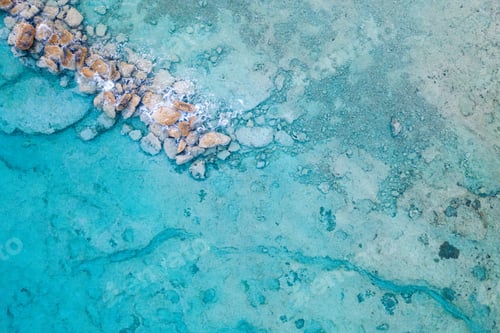 Preview: Aerial view of clear blue sea with rocks