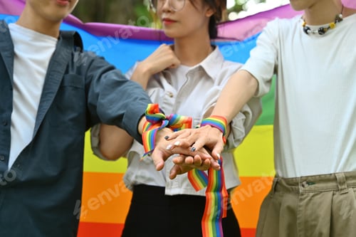 Preview: Group of young people stacking hands together, showing freedom and unity.