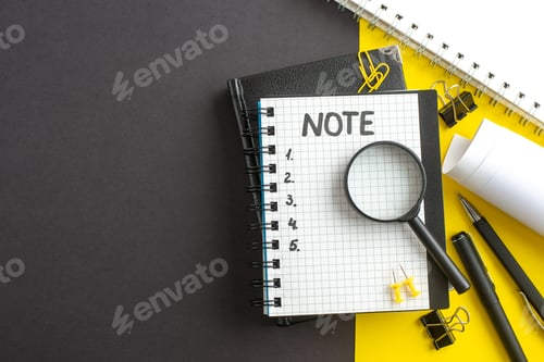 Preview: top view open notepad with note and numbers inside on dark-yellow background office success