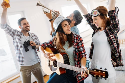 Preview: Group of friends playing guitar and partying at home