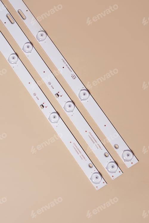 Preview: LED strips with lamps for LCD TV or monitor on a light background. Repair of TV, monitor. Top view.