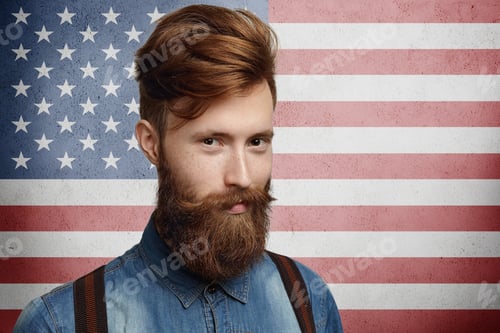Preview: National identity and citizenship concept. Studio shot of good-looking unshaven Caucasian macho dres