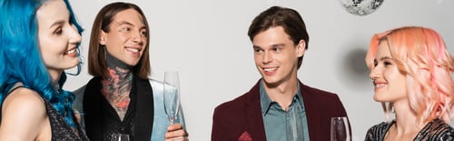 Preview: happy queer people holding champagne glasses during christmas party on grey background, banner