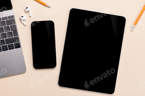 Preview: Blank screen smartphone and tablet on a desk