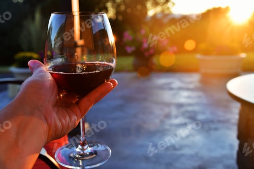 Preview: Glass of Red Wine During Golden Hour