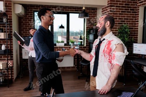 Preview: Businessman doing handshake with evil zombie