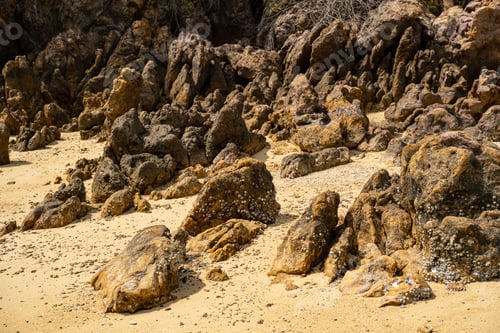 Preview: Rocky shore and clean sand stock photo