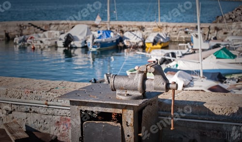 Preview: Hand vise on metal bench in harbor.