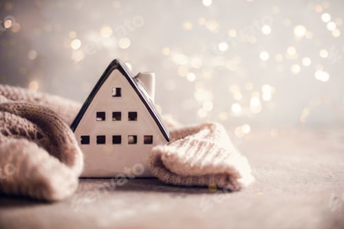 Preview: Ceramic house insulated by warm sweater. Winter holiday card