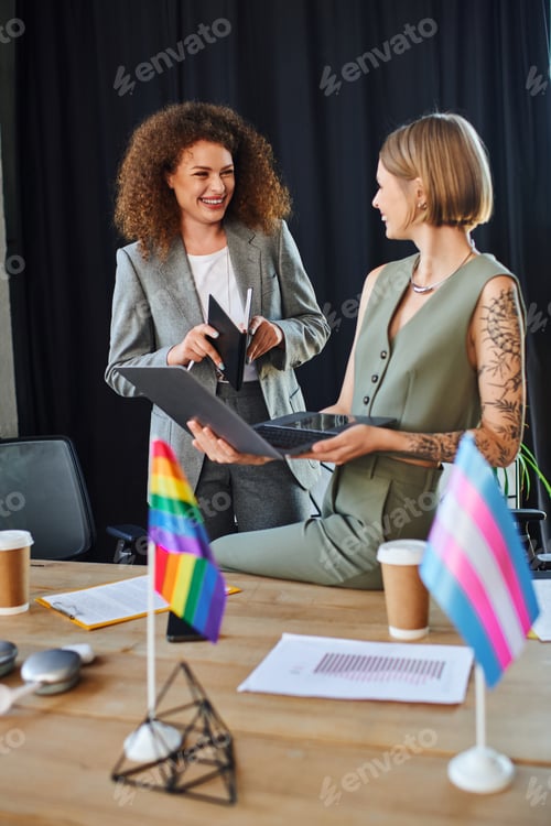 Preview: Two coworkers share a joyful moment while celebrating diversity and inclusion at work