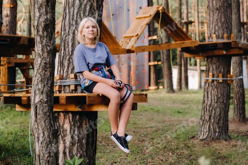 Preview: A girl passes an obstacle in a rope town. A girl in a forest rope park