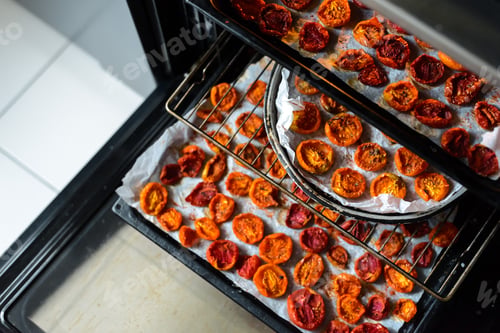 Preview: Trays of fresh cherry tomatoes on racks drying in the oven
