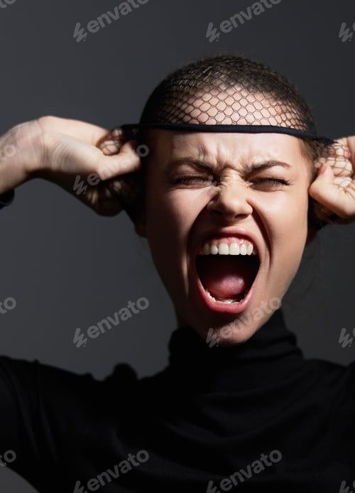 Preview: Frustrated woman in black turtleneck pulling hair, expressing emotions. Dark background enhances