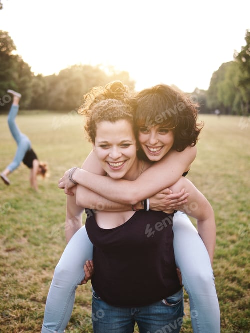 Preview: young lesbian couple enjoying a summer day at the park
