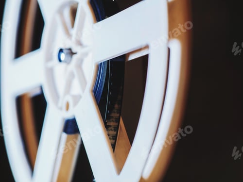 Preview: Front view of old-fashioned antique Super 8mm film projector, projecting beam of light in dark room