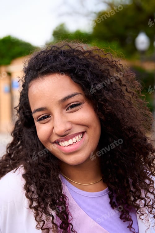 Preview: Beautiful happy African American girl. Portrait of cheerful young Latina woman standing outdoors