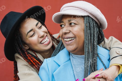 Preview: Happy african mother having tender moment with adult daughter - Family love concept