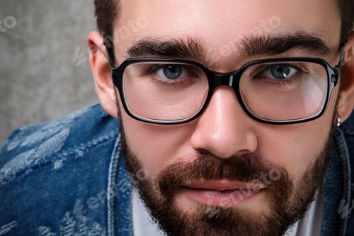 Preview: Intense Portrait of a Bearded Man Wearing Glasses