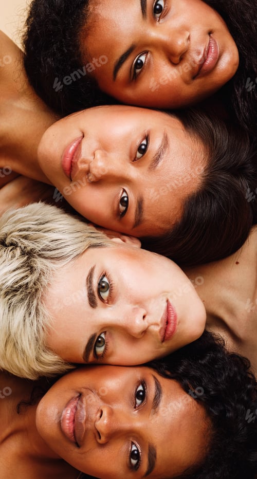 Preview: Beautiful young women lying on top of each other, looking at camera