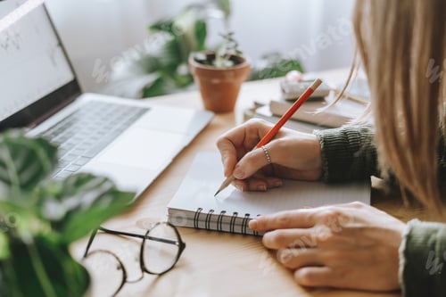Preview: Distance learning online education and work. Business woman writes in notebook, with laptop