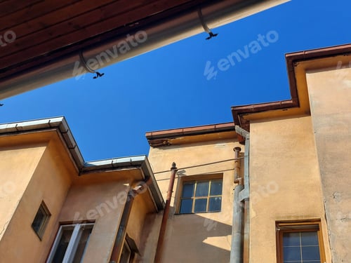 Preview: Architectural detail, of old urban building wall against blue sky