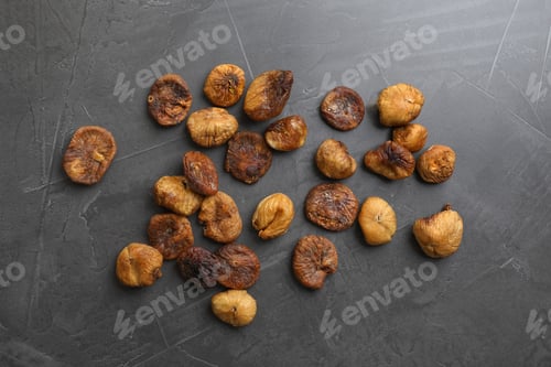 Preview: delicious dried figs on grey background, top view. Organic snack