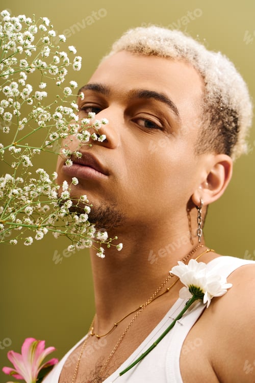 Preview: Young African American man showcases trendy style with floral accents in studio setting