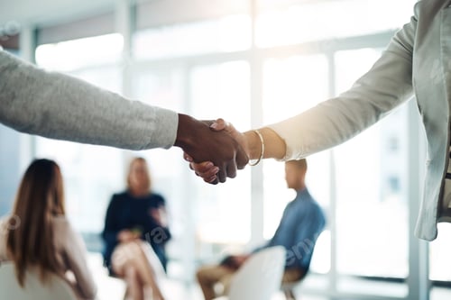 Preview: Cropped shot of two unrecognizable colleagues shaking hands during a meeting in the office