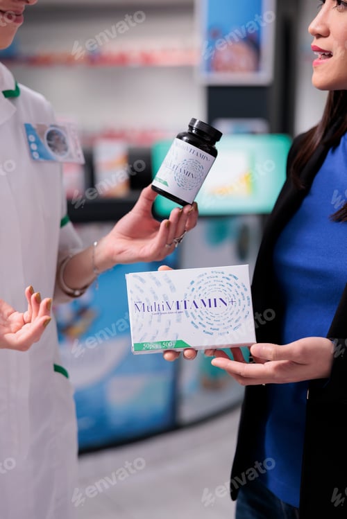 Preview: Woman choosing between multivitamin packages in drugstore