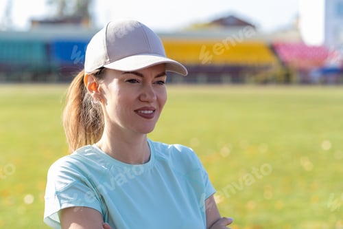 Preview: A young beautiful woman in sportswear plays sports at a local stadium