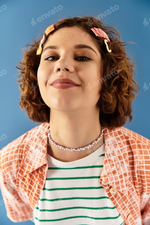 Preview: Vibrant summer fashion portrait of a young woman with curly hair on blue backdrop
