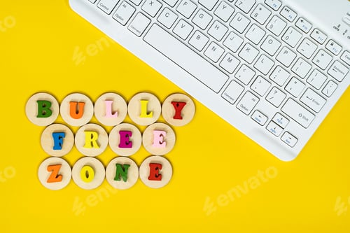 Preview: Layout of wooden alphabet on wooden tiles with text "BULLY FREE ZONE" next to a keyboard