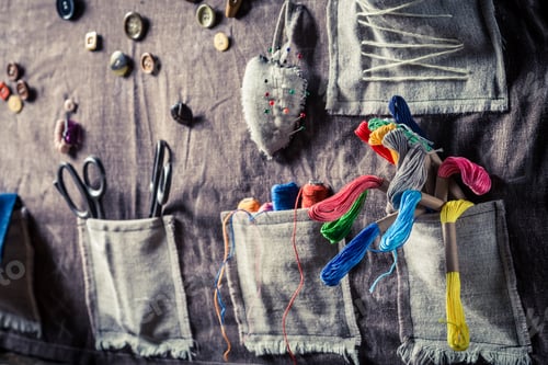 Preview: Sewing mat with threads, scissors and buttons in tailor workshop