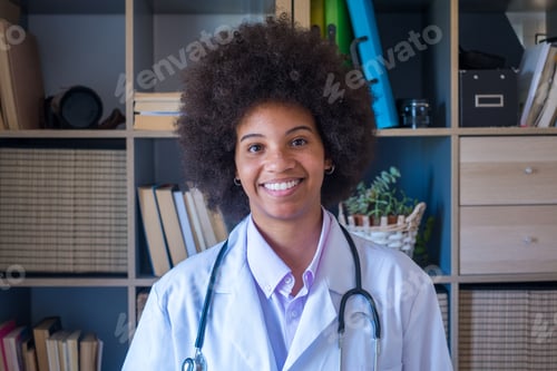 Preview: Happy female african american doctor with stethoscope at her clinic. Confident frontline heathcare